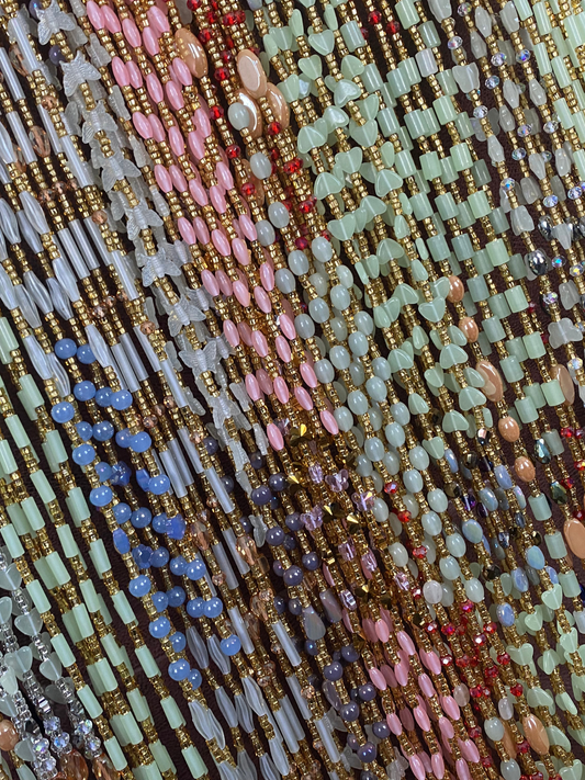 Close-up of multicolored beaded Waist Bead strands- Glow in the dark