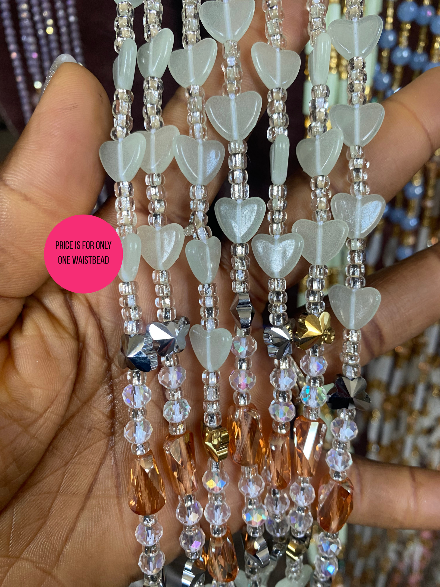 Beaded Subtle Glow in the dark waist beads with heart-shaped beads held by a hand
