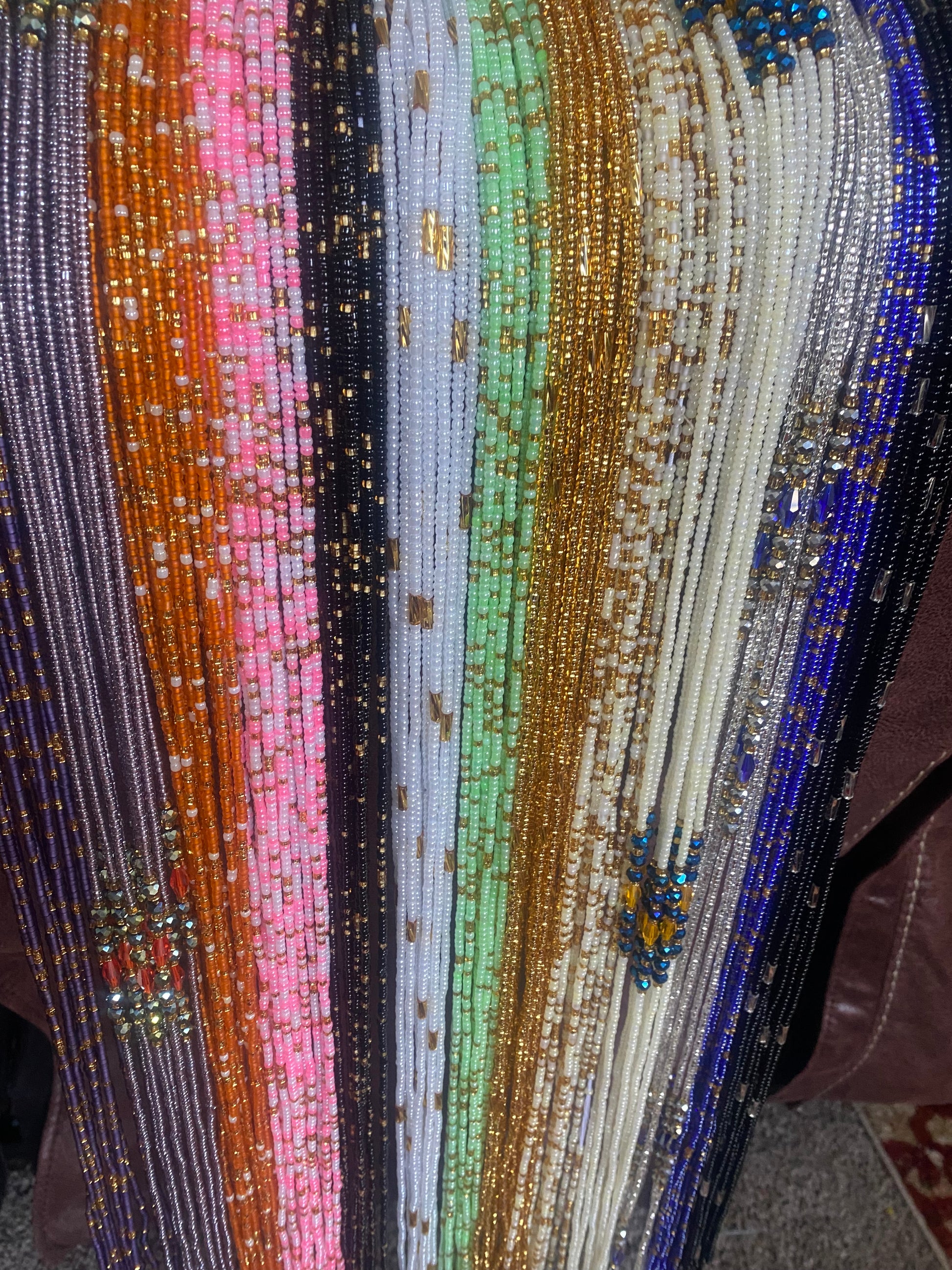 Colorful beaded fabric with a gradient of colors.