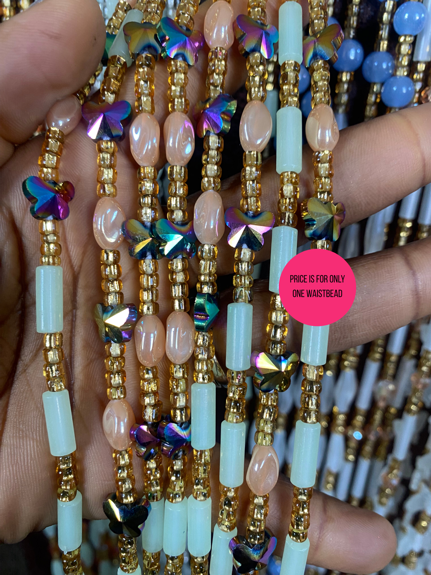 Close-up of Beaded Subtle Glow in the dark waist beads with a pink price tag on a blurred background